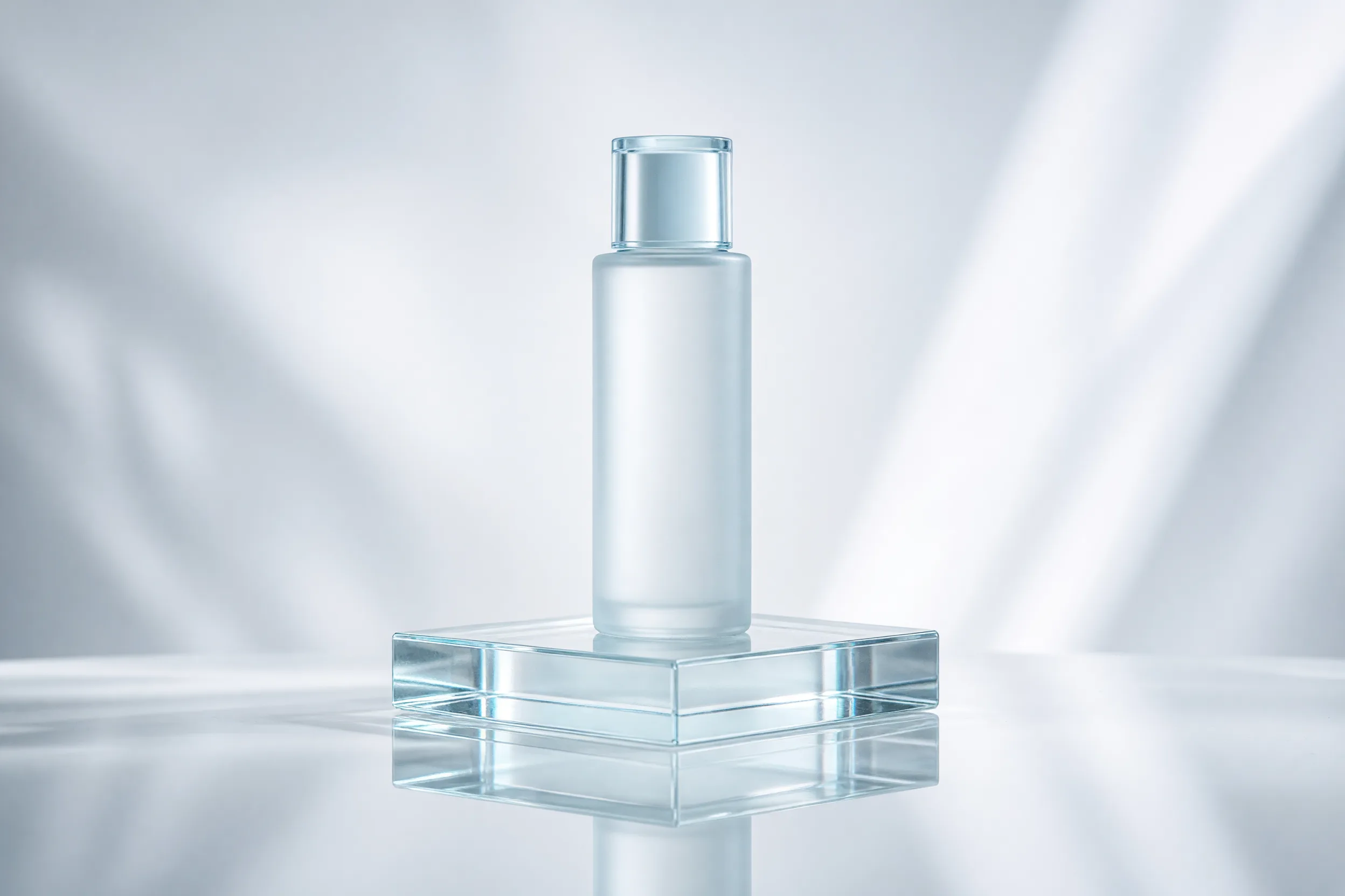 glass reflection product look: white skincare bottle standing on a clear glass block with a sharp mirror line under it